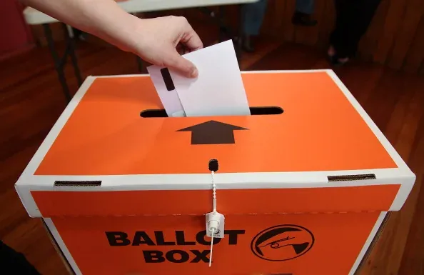 WELLINGTON, NEW ZEALAND, NOVEMBER 20: A voter places a ballot paper into the ballot box during the Mana By-Election at Cannons Creek School polling booth on November 20, 2010 in Wellington, New Zealand. The Mana seat was vacated by former Labour Pacific Island Affairs Minister Winnie Laban, who…